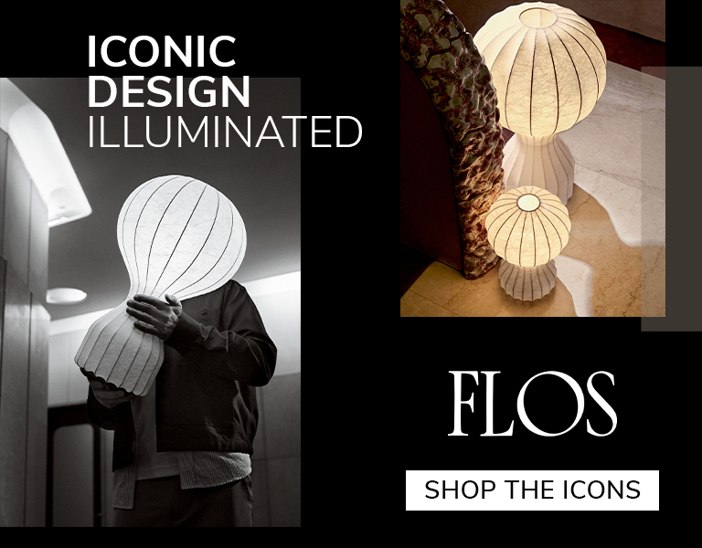 Shop the icons Designer holding illuminated Flos lamp with sculptural paper shade, alongside glowing floor lamps in warm tones, promoting ‘Iconic Design Illuminated’ and ‘Shop the Icons’ campaign.