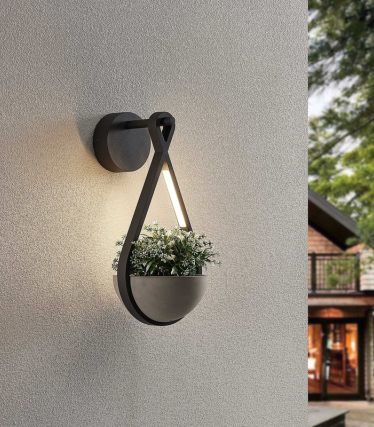 "Applique murale avec jardinière intégrée, lumière chaude sur une façade claire.  "