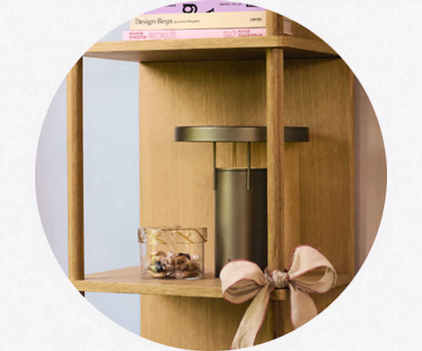 Designer table lamp displayed on a wooden shelf with decorative ribbon and gift-inspired styling